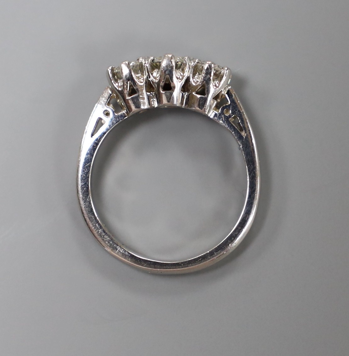 A modern platinum and three stone diamond ring, size H, gross weight 4.8 grams.